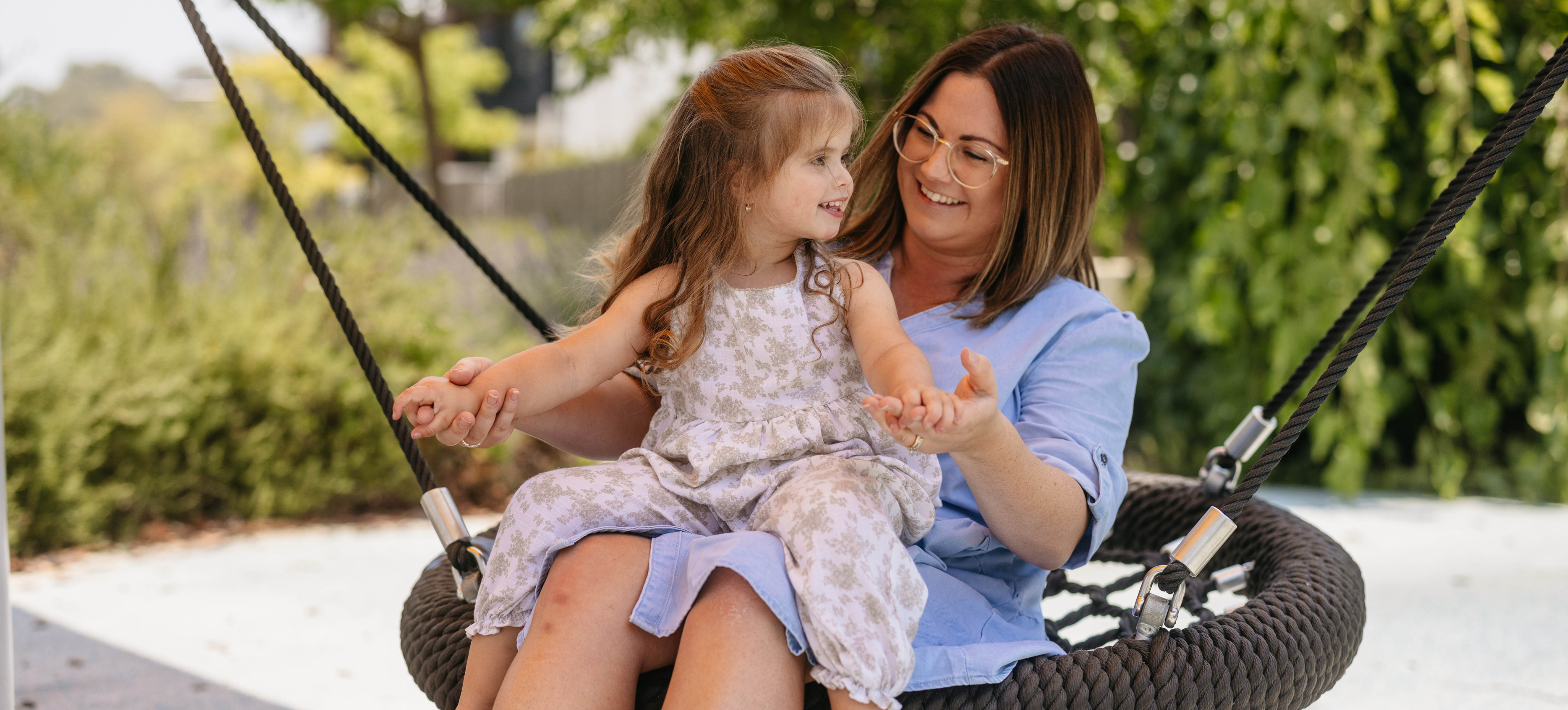 Child and mother on a swing at 